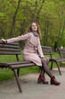 © shymar27 - Portrait of a beautiful red-haired girl in a gray coat in a city park.