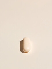 Aufkleber - Capsule on Beige: A simple still life featuring a soft beige capsule set against a matching backdrop, highlighting minimalism and neutral tones.
