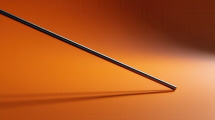 Leinwandbilder - A long, thin metal rod is sitting on a red surface