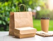 © Ankur - Food delivery container mockup on a table with eco-friendly utensils and paper bag