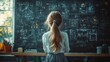 © Tatyana - Young girl with long hair tied in a ponytail standing and studying complex mathematical or scientific formulas on a chalkboard in a classroom filled with natural light