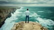 © Af - Man on cliff overlooking dramatic ocean waves stormy sky