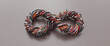 © chawalit - Red, black, yellow and blue electrical or signal wires twisted together in an infinity symbol shape on a grey background. Retro analog technology. Object with clipping path. 3D Illustration.