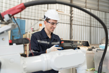 Fototapete - Robotic arm, Automatic robotic arm welding. Robotic manufacturing industry. Engineer setup, install, maintain, repair mechanism of operation of robotic arm in storage warehouse