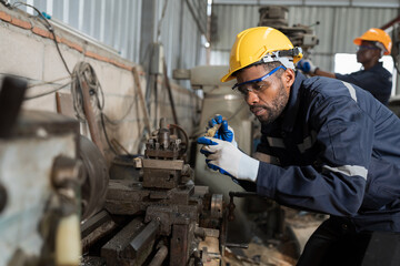 Fototapete - Manufacturing industry, machine and engineer setup, maintain, repair mechanism of operation of lathe machine in machinery warehouse