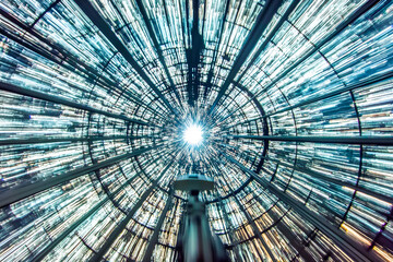Aufkleber - Abstract architectural perspective featuring radiating lines converging toward a bright light source within a glass structure creating a mesmerizing visual display.