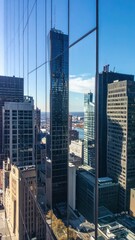 Poster - Modern City Skyline Reflection in Polished Glass Facades of Skyscrapers
