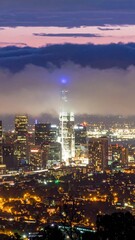 Poster - City Skyline at Night with Lights Reflecting off Low Clouds