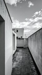 Poster - Mysterious Rooftop Space with Hidden Corners and Cloudy Skies