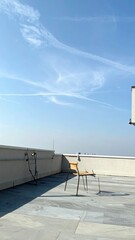 Poster - Single Chair on Rooftop Edge Invites Contemplation and Serenity