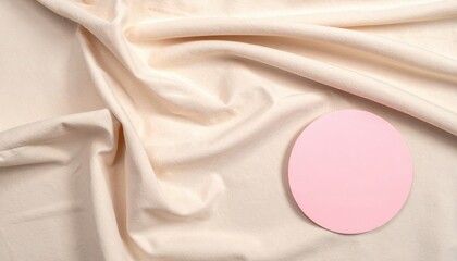 Poster - Artistic flat lay of pink circle on cream fabric studio setting visual content minimalist concept