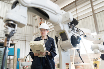 Aufkleber - Robotic arm, Robotic manufacturing industry. Woman engineer control robotic arm to adjust working mechanism in workshop