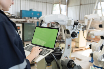 Aufkleber - Robotic arm, Robotic manufacturing industry. Woman engineer working with laptop computer for setup, install, maintain, repair mechanism of operation of robotic arm in workshop