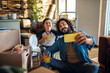 © Marko Geber - Young father and son taking a selfie after moving in their new home apartment