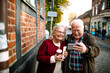 © Davor - Happy senior couple taking selfie on vacation in European city street
