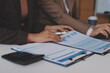 © Sirikarn Rinruesee - Accounting company provide finance and taxation planning for profitable cash flow, Auditor and accountant team working in office, analyze financial data and accounting record with calculator.Insight