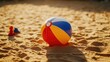 © somsri - Inflatable beach ball with nearby sand toys on golden sand, perfectly lit for a bright and playful stock photo