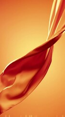 Poster - Flowing Red Fabric Against Warm Orange Backdrop in a Dynamic Video