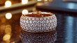 © Md.Al-amin - A close-up macro photograph of an elegant rose gold diamond ring on a reflective black surface.