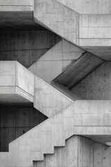 Poster - Geometric concrete staircase with angular lines and hexagonal windows on a modern architectural facade.