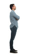 © 1STunningART - Full length side view portrait of a serious young man with crossed hands looking ahead isolated on transparent background. Confidence and charisma