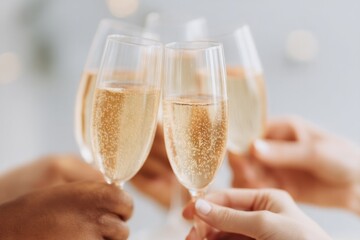 Poster - close-up of diverse hands raising glasses in toast at festive gathering emphasizing joyful