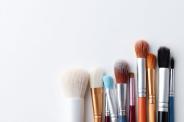 Aufkleber - flat lay of varied style paintbrushes on plain white canvas with ample copy space around brushes