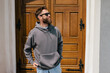 © San4ezz007 - Bearded hipster in dark grey hoodie and sunglasses – urban apparel mockup