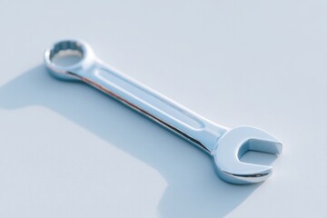 Poster - single mechanic wrench resting on clean light-colored surface casting soft shadow