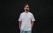 © San4ezz007 - White T-shirt on a bearded hipster in sunglasses — urban mockup for brands