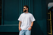 © San4ezz007 - White T-shirt on a bearded hipster in sunglasses — urban mockup for brands