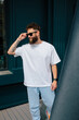 © San4ezz007 - White T-shirt on a bearded hipster in sunglasses — urban mockup for brands