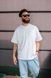 © San4ezz007 - White T-shirt on a bearded hipster in sunglasses — urban mockup for brands