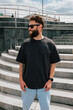© San4ezz007 - Bearded hipster in black t-shirt and sunglasses — urban mockup for brands