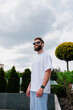 © San4ezz007 - White T-shirt on a bearded hipster in sunglasses — urban mockup for brands