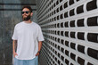 © San4ezz007 - White T-shirt on a bearded hipster in sunglasses — urban mockup for brands