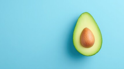 Poster - minimalistic top-down shot of single ripe avocado finely sliced lay on spacious clean solid color backdrop with ample