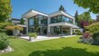 © Ірина Пальцева - Modern architectural home featuring expansive glass windows. Beautiful lawn and landscape add to the setting.