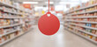 © A2Z AI  - A red round tag suspended in a supermarket aisle, suggesting a sale or special offer amid blurred shelves filled with assorted products.
