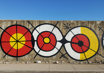 Poster - Mural with colorful graphic art featuring circles and lines on a concrete wall creating an eye-catching mural art piece with vibrant colors and geometric shapes mural