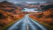 © ROY - Winding road through autumnal landscape.  Misty mountains and lake in the distance