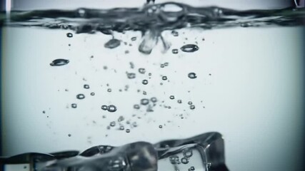 Poster - Close up view of ice cubes falling into clear water with many bubbles