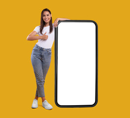 Aufkleber - Cool Mobile Offer. Happy casual lady leaning on huge cellphone with empty white screen, showing thumb up, recommending great new app or website for cell phone, offering space for your ad, mock up