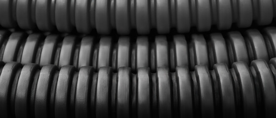 Poster - Dark black close up of corrugated industrial plastic pipes as industrial concept background