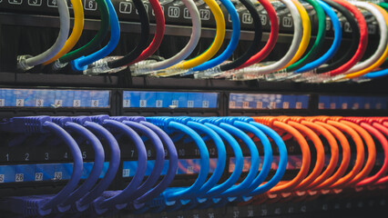 Poster - A row of cables with different colors and numbers. The cables are connected to a black box. Internet and communications concept