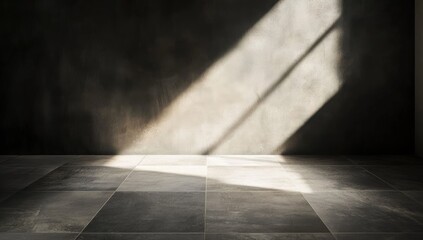 Wall Mural - a sunlit diagonal beam illuminates a dark room with a textured wall and a tiled floor, creating stro