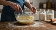 © Taqinaya - Woman baking cake mixing ingredients in glass bowl on wooden table