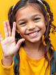 © Stacy - Young girl smiling with sympathetic hand gesture. Isolated on yellow background