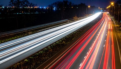 Poster - A long exposure shot captures the vibrant light trails of vehicles on a highway at night, showcasing the dynamic flow of urban traffic