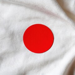 Poster - Minimalist Japan flag concept on white silky fabric top down view for travel and culture themes